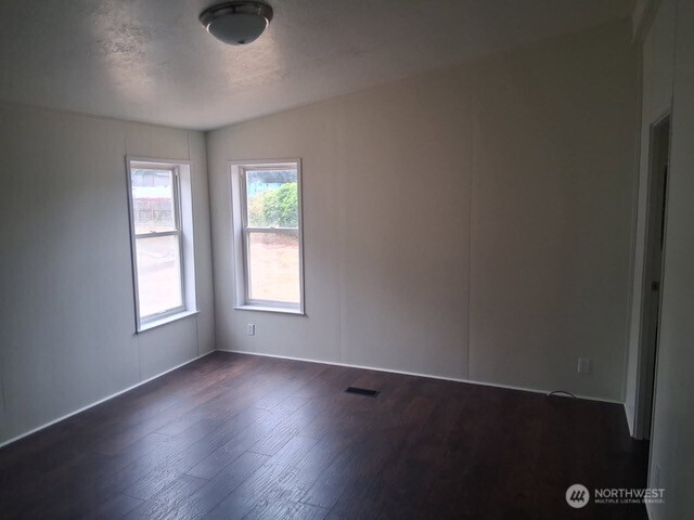 915 Union Mills Road Southeast, Unit 11 Lacey, WA 98503 - Photo 10 of 15 an empty room with wooden floor and windows