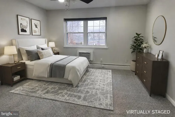 a bedroom with a large bed and a potted plant