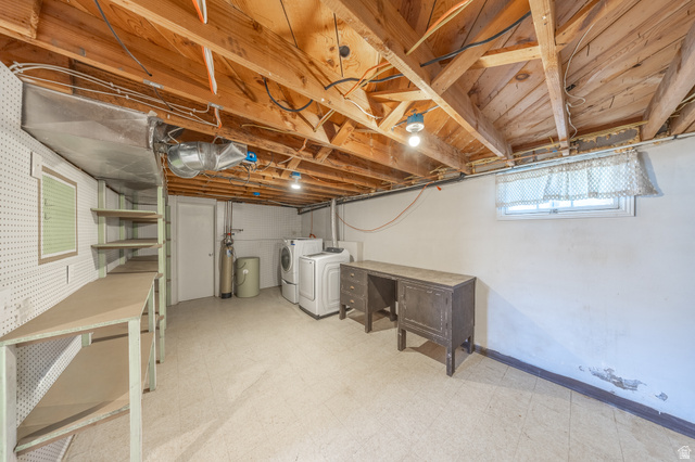 193 Locust Street Clearfield, UT 84015 - Photo 16 of 29 Spacious basement area featuring exposed wood joists, utility sink, washer and dryer, and built-in shelving