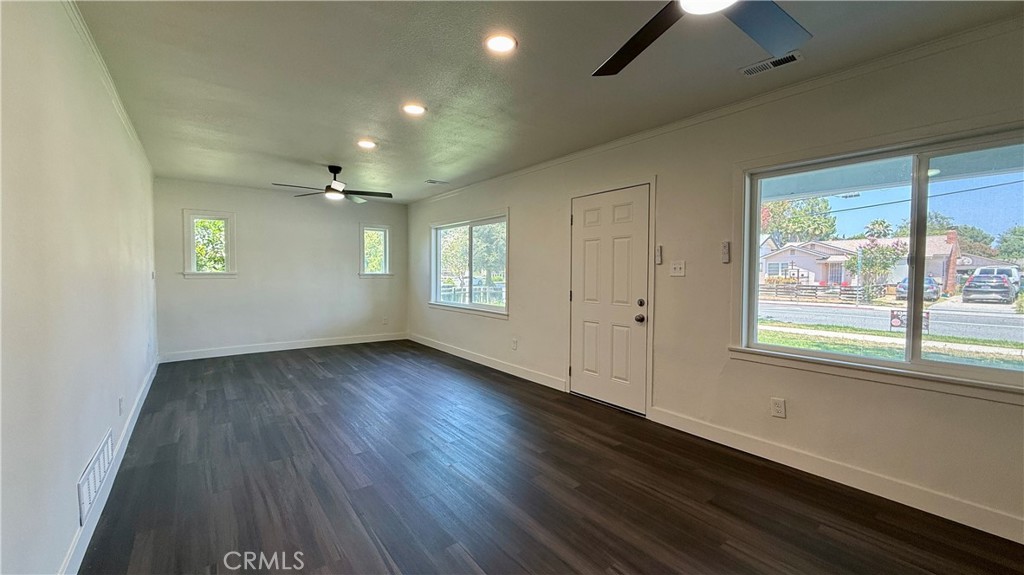 4542 Bandini Avenue Riverside, CA 92506 - Photo 6 of 22 an empty room with wooden floor and windows