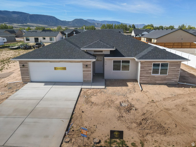 910 East Remington Road Cedar City, UT 84721 - Photo 2 of 29 Contemporary single-story residence with a dark shingle roof and a light stucco exterior
