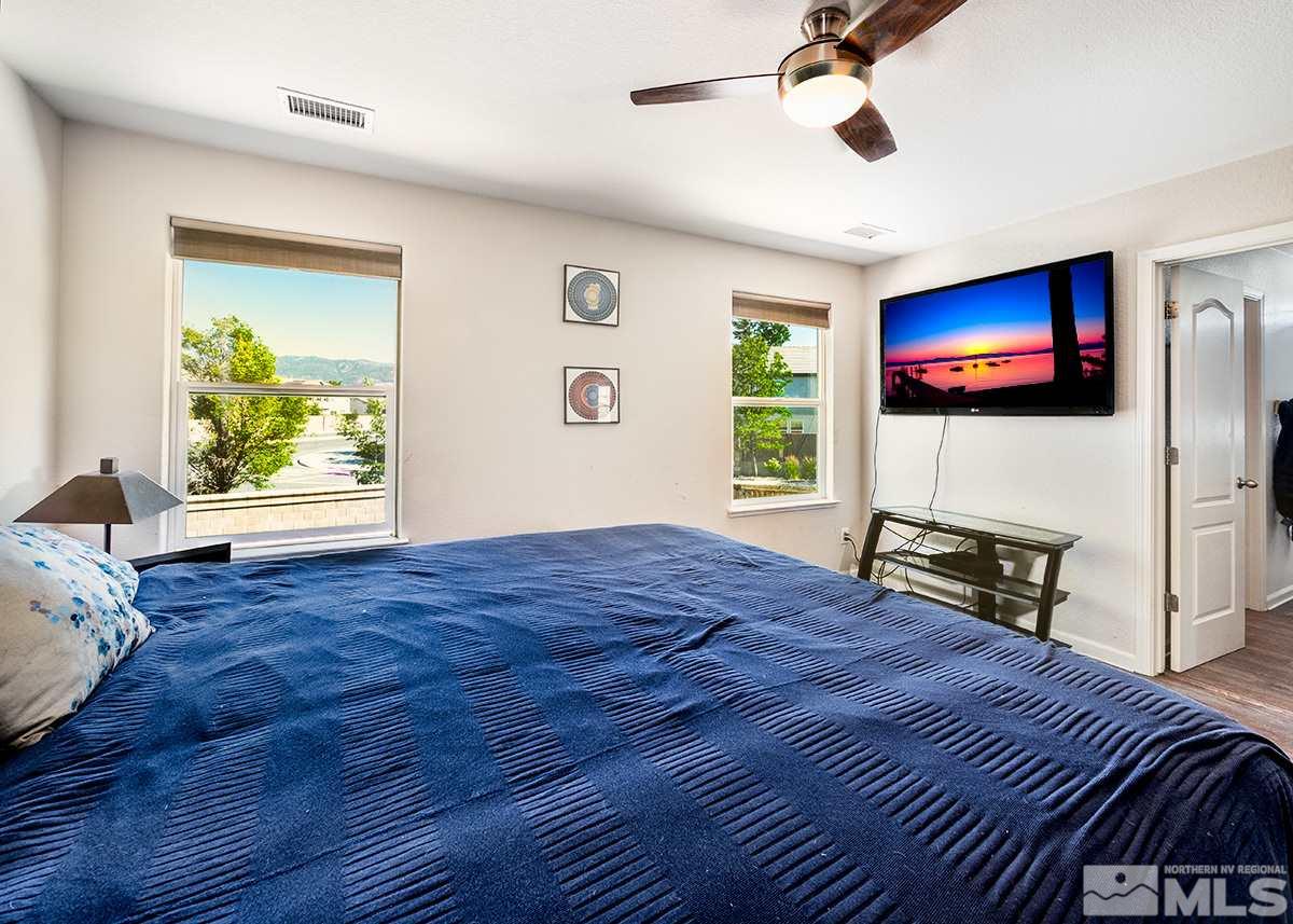 590 Verelli Court Reno, NV 89521 - Photo 18 of 23 a bedroom with a bed and a flat screen tv
