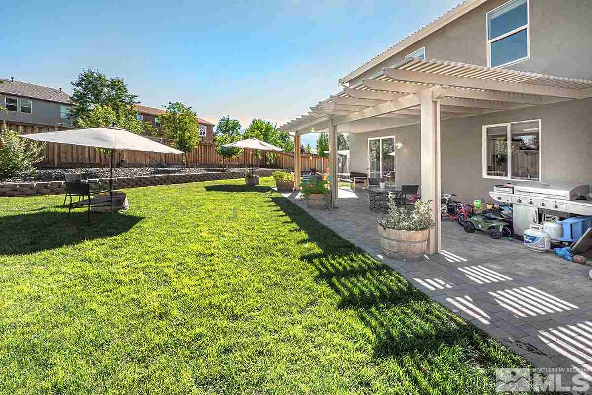 590 Verelli Court Reno, NV 89521 - Photo 22 of 23 a view of a patio with chairs and table under an umbrella