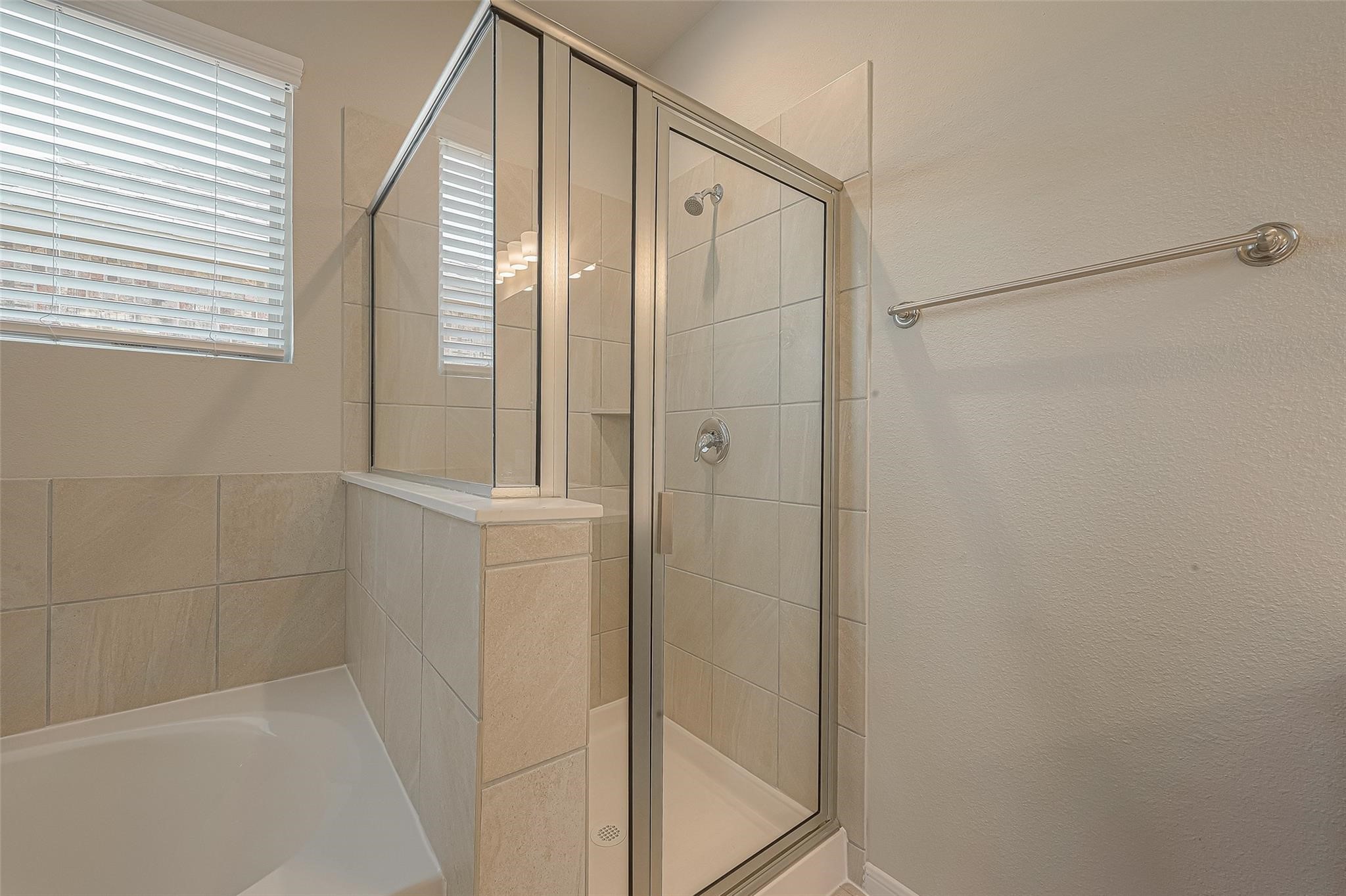 13314 Prado Rdg Lane Iowa Colony, TX 77583 - Photo 31 of 35 a bathroom with a bathtub and a shower