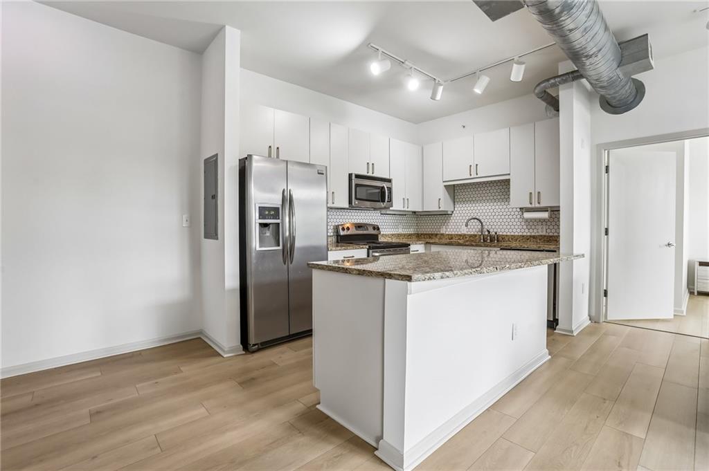 5300 Peachtree Road, Unit 3506 Atlanta, GA 30341 - Photo 2 of 25 a kitchen with stainless steel appliances granite countertop a refrigerator a stove a sink and a microwave