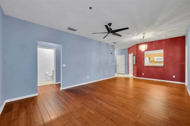a view of empty room with wooden floor