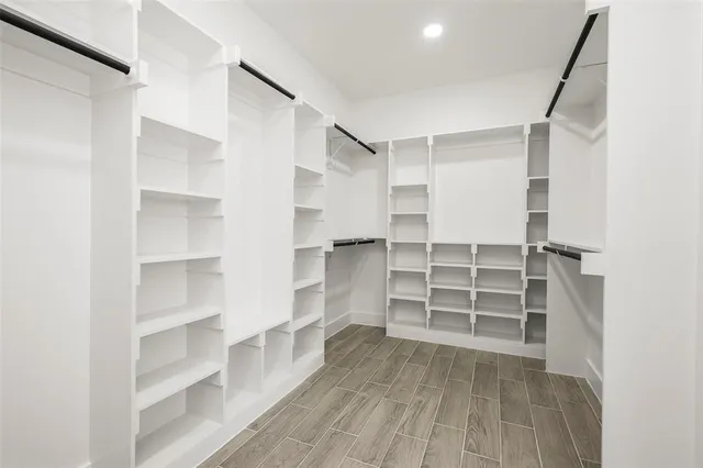 a view of walk in closet with empty racks