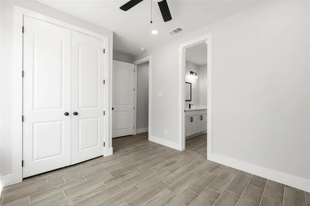 a view of a hallway with wooden floor and closet area