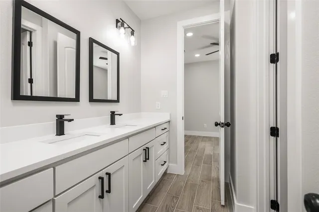 a bathroom with 2 sink and a mirror