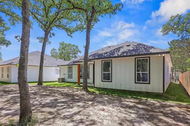 a view of a house with a tree in front