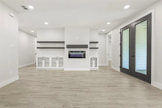 a view of a kitchen with stainless steel appliances a refrigerator and a stove top oven