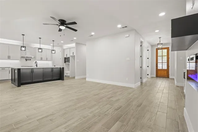 a view of a livingroom with furniture and an empty room