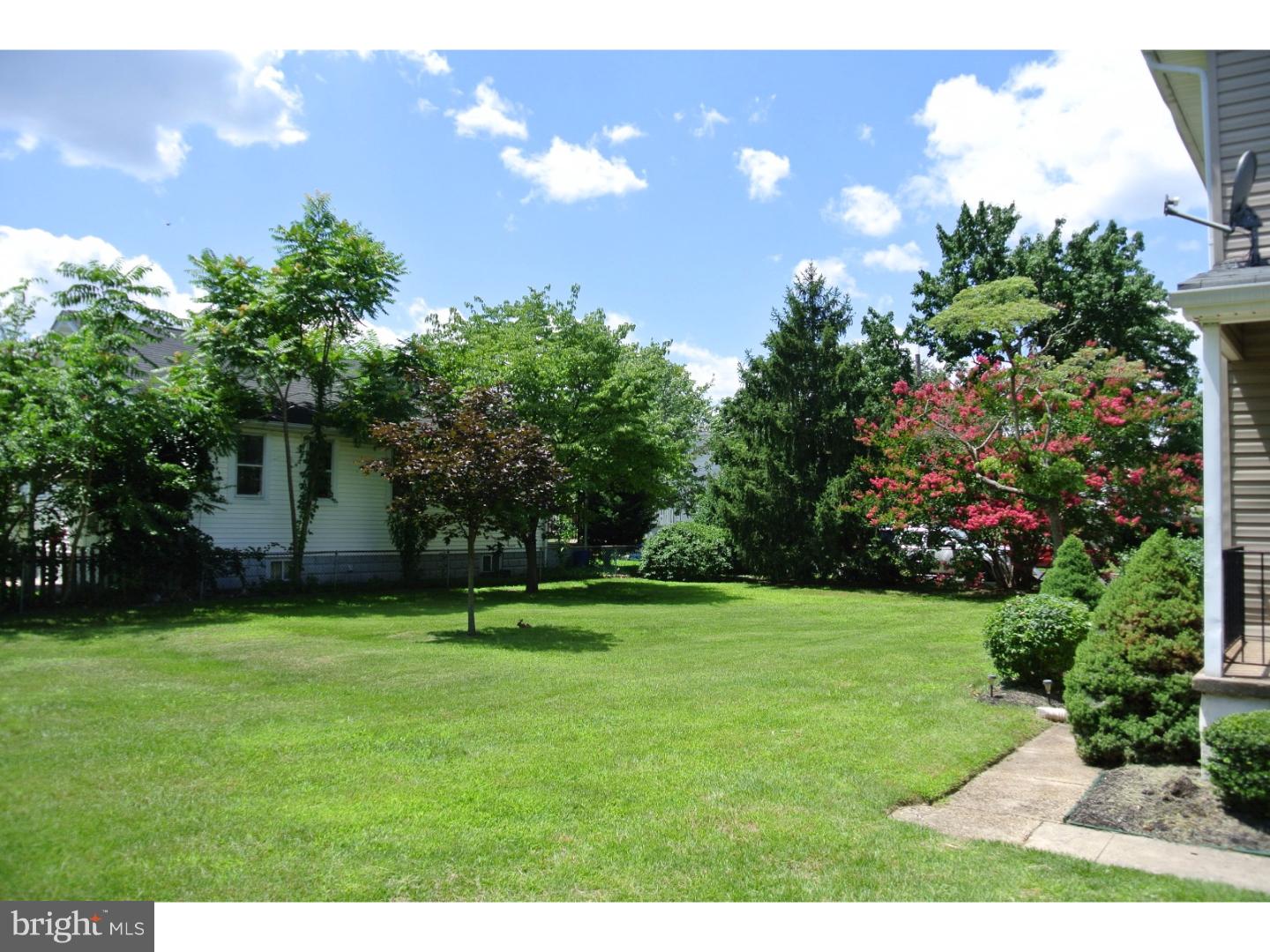214 Grant Street Riverside, NJ 08075 - Photo 22 of 24 a backyard of a house with lots of green space and outdoor seating
