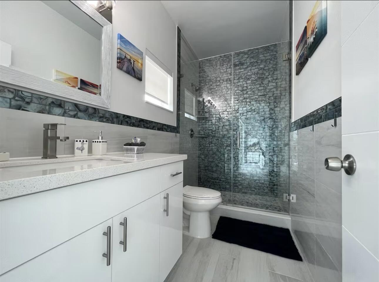 1021 82nd Street Marathon, FL 33050 - Photo 20 of 33 a bathroom with a sink a toilet a mirror and shower