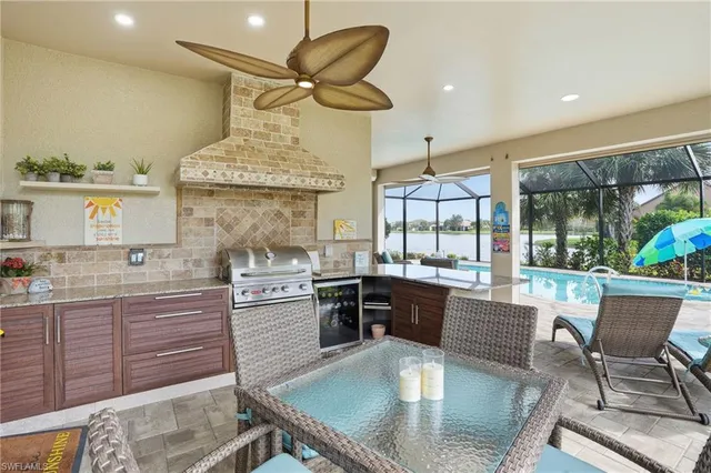 a kitchen with stainless steel appliances granite countertop a sink table and chairs