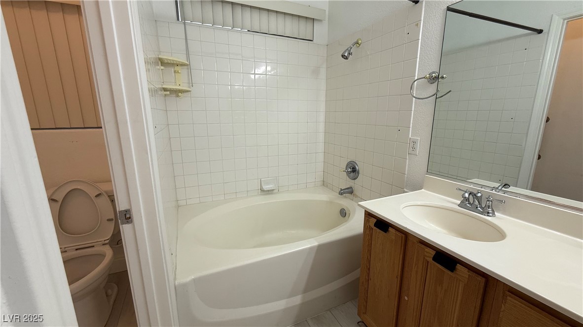 7062 Russell Ranch Avenue Las Vegas, NV 89113 - Photo 27 of 32 Full bath featuring toilet, vanity, and bathing tub / shower combination