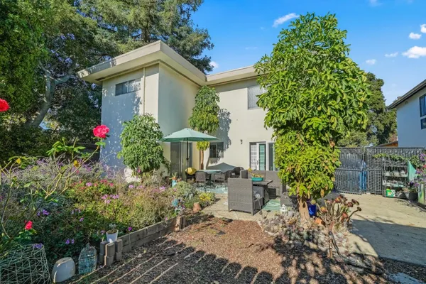 a front view of a house with a yard and fountain
