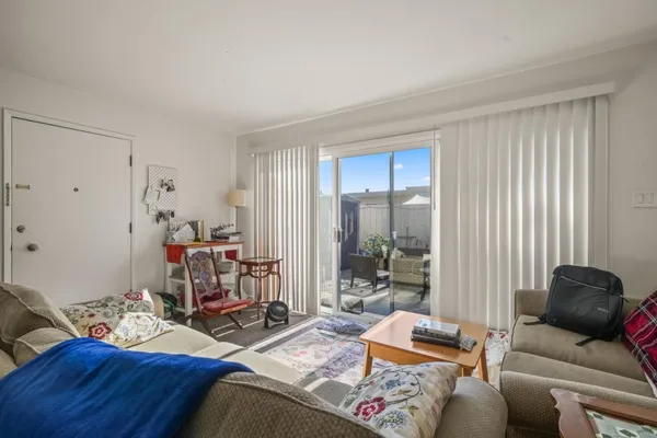 a living room with furniture and a mirror