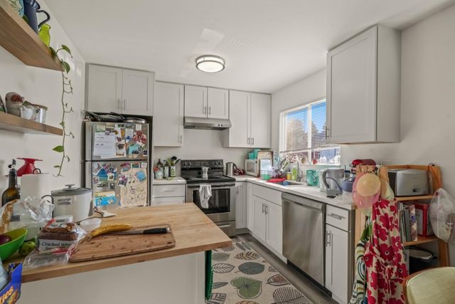 a kitchen with a stove a sink and cabinets