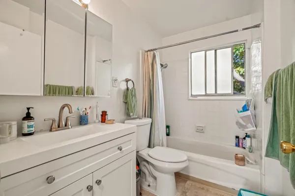 a bathroom with a sink a toilet and a bathtub