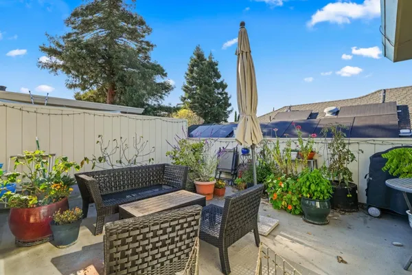 a outdoor dining space with furniture and potted plants