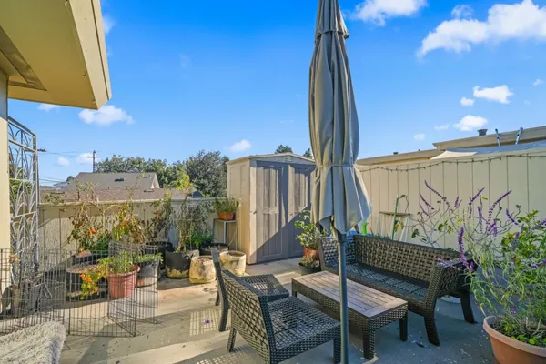 a view of a chairs and table in patio