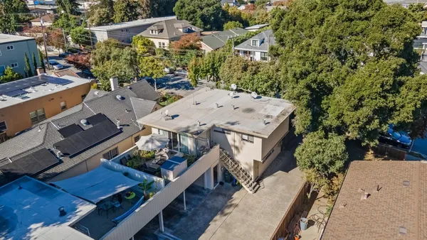 an aerial view of a house with a yard