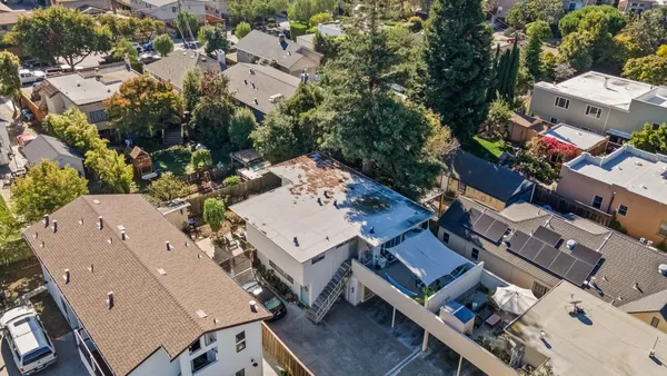 an aerial view of a house with a yard