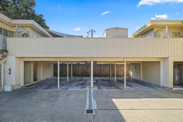 a view of a house with a patio and a yard