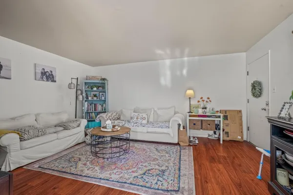 a living room with furniture and wooden floor