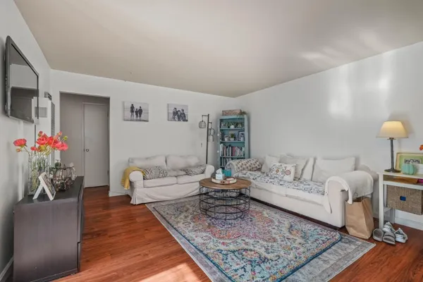 a living room with furniture and wooden floor