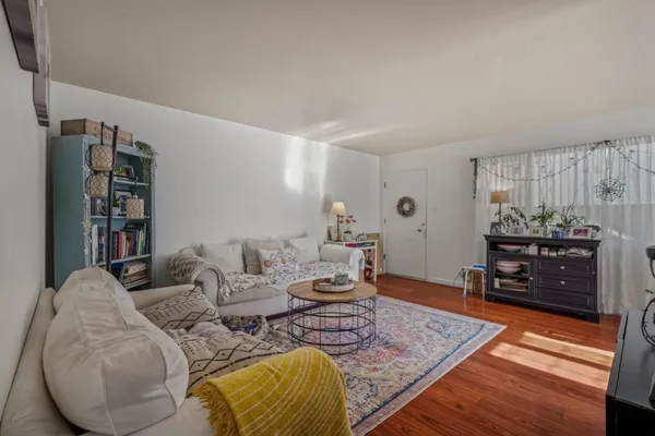 a living room with furniture and wooden floor