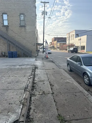 a view of a cars park in front of a house