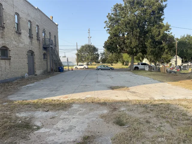 a view of a dirt road and a building