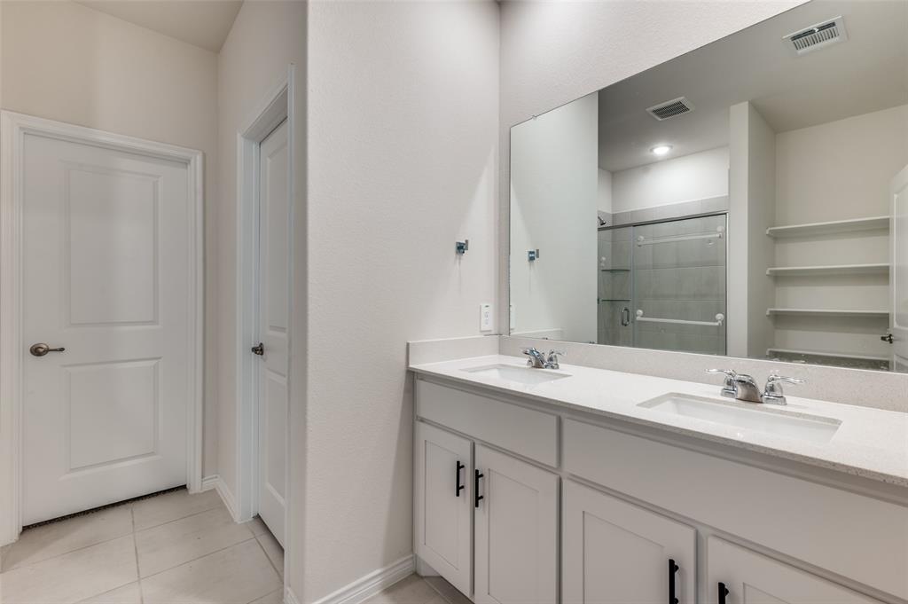 3876 Lyndhurst Avenue Little Elm, TX 75068 - Photo 12 of 25 a bathroom with a sink double vanity and a mirror