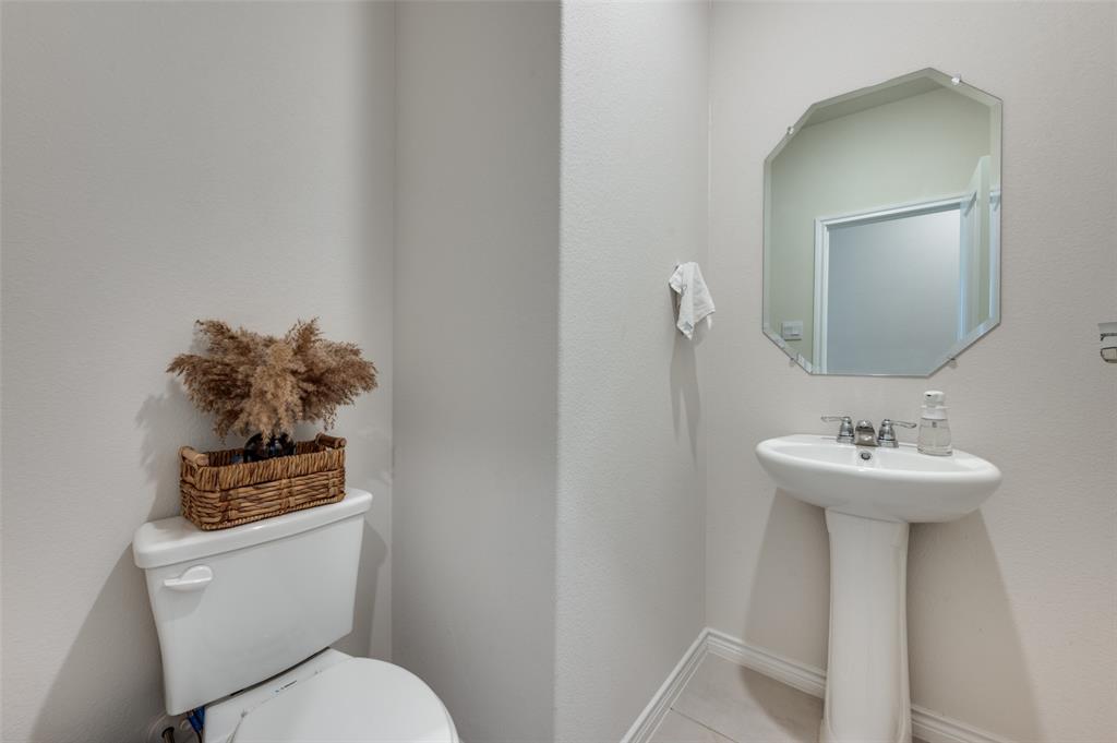3876 Lyndhurst Avenue Little Elm, TX 75068 - Photo 13 of 25 a bathroom with a toilet sink and mirror