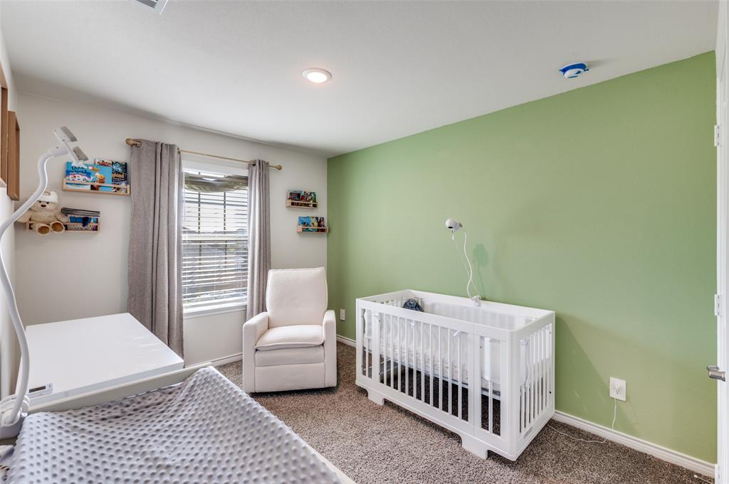 3876 Lyndhurst Avenue Little Elm, TX 75068 - Photo 18 of 25 a bedroom with a bed and wooden floor