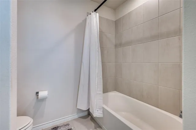 a bathroom with a bathtub and a toilet