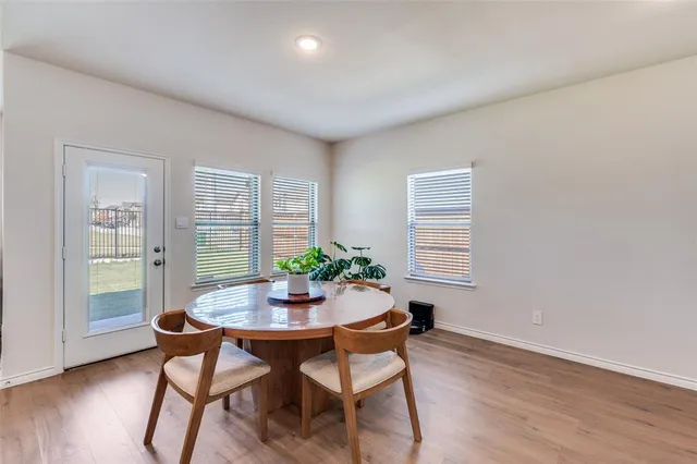 a dining room with furniture and wooden floor