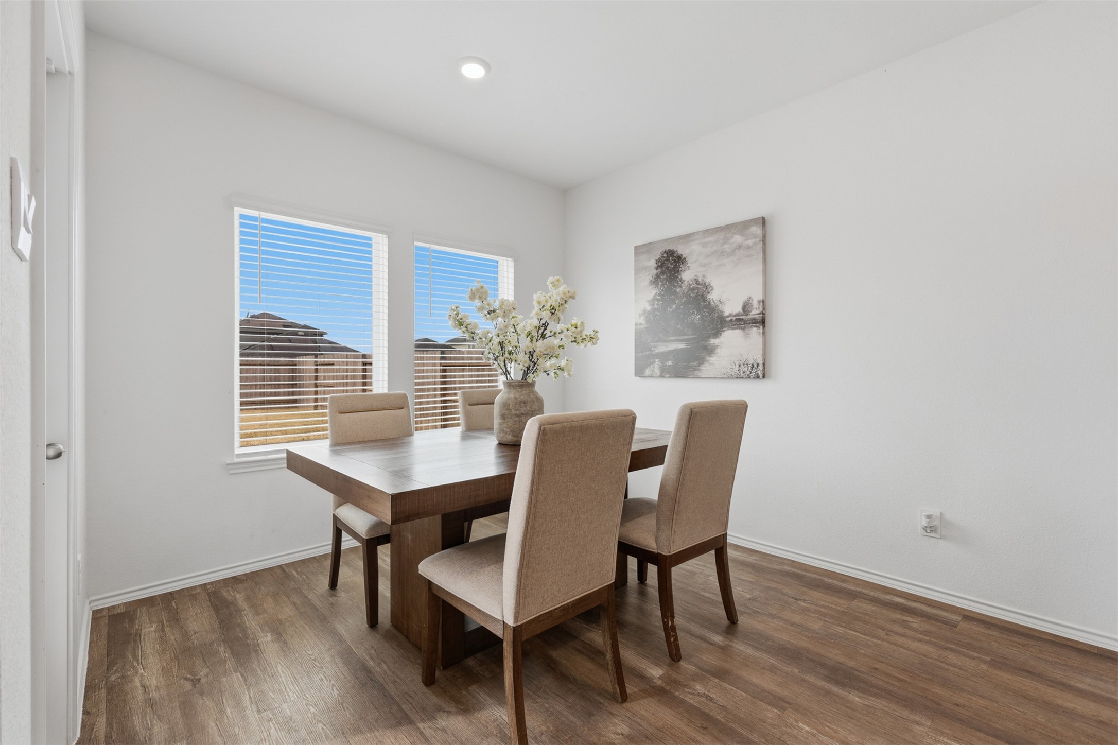 17719 Winfall Drive Crosby, TX 77532 - Photo 21 of 47 Natural light streams through two windows, highlighting the light flooring. A serene wall art piece adds a touch of elegance.