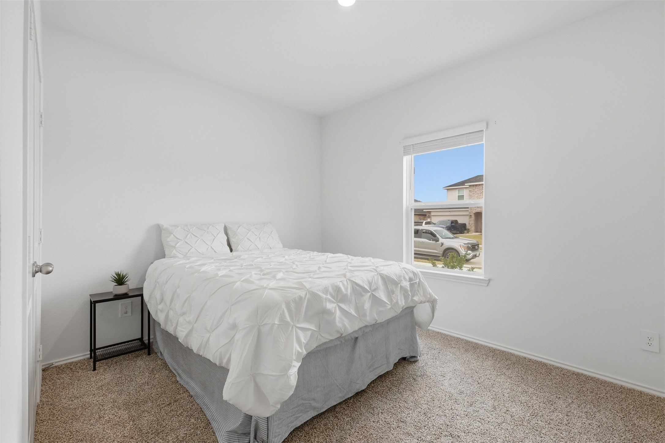 17719 Winfall Drive Crosby, TX 77532 - Photo 34 of 47 This third bedroom features a cozy space with neutral tones, a large window for natural light, and a simple closet. Perfect for a comfortable retreat.