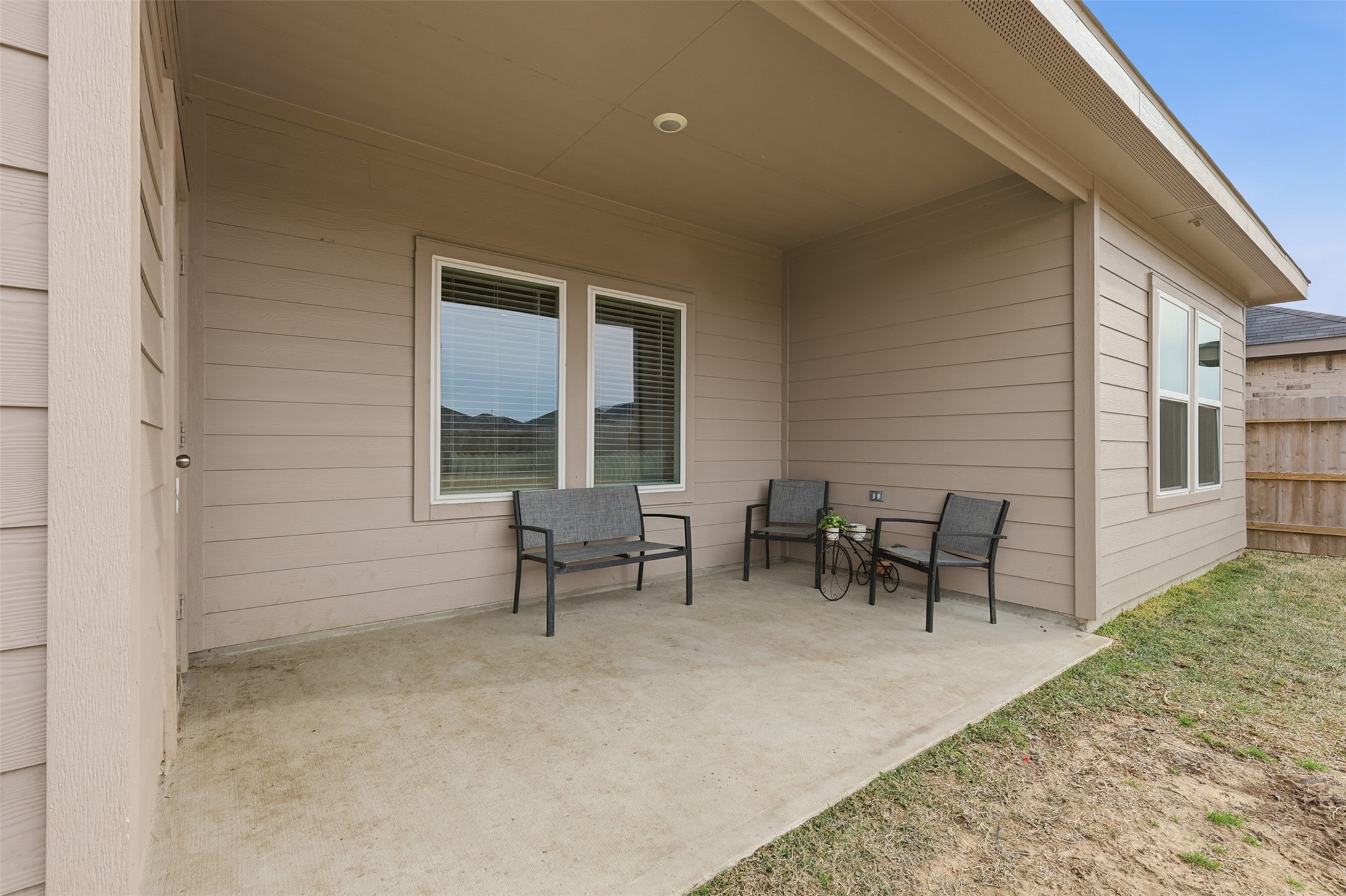 17719 Winfall Drive Crosby, TX 77532 - Photo 42 of 47 Cozy covered patio perfect for outdoor relaxation. It features neutral siding and overlooks a grassy yard, providing a private and inviting space.