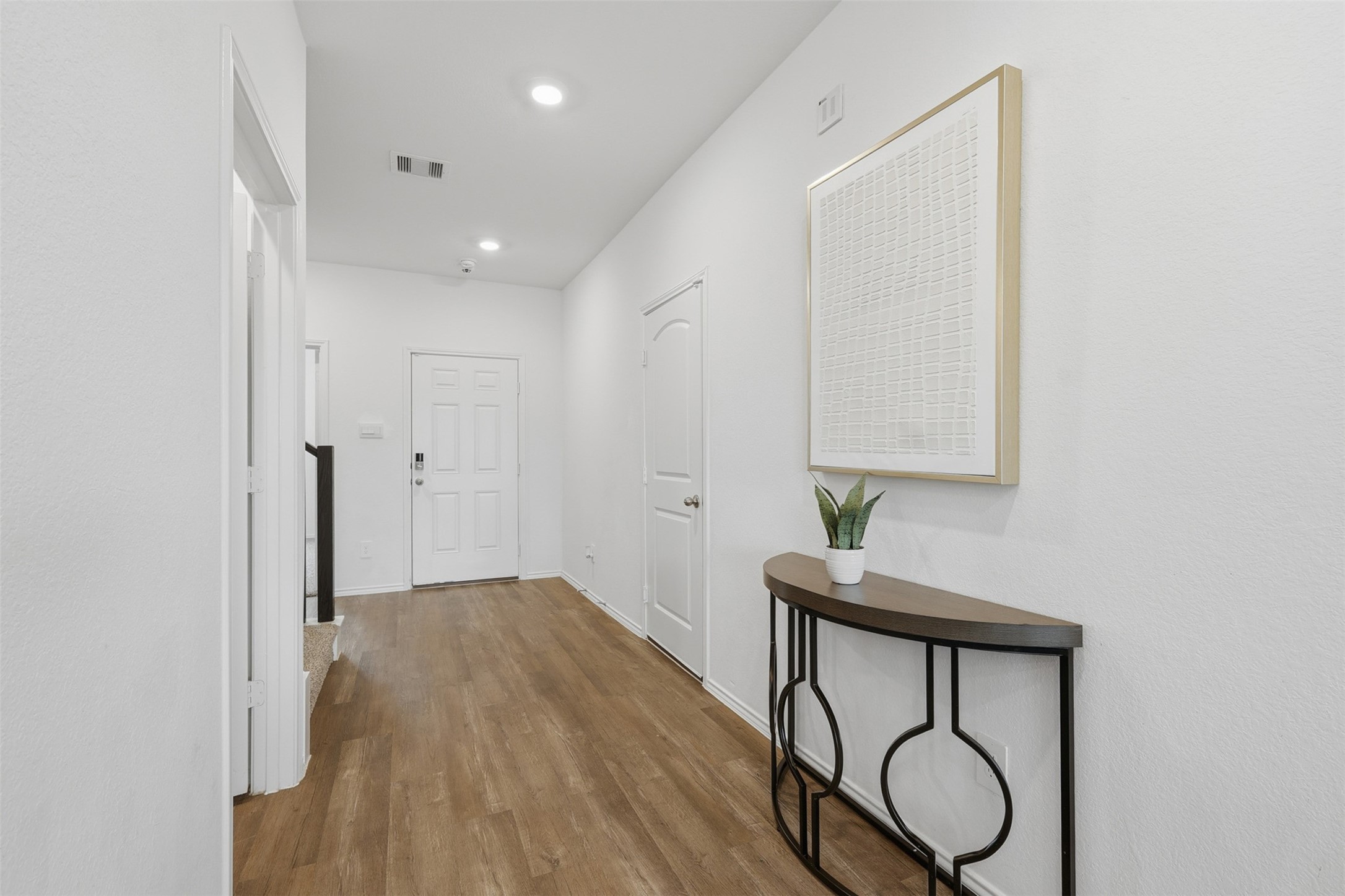 17719 Winfall Drive Crosby, TX 77532 - Photo 8 of 47 This photo showcases a bright, welcoming entryway. The hallway leads to a staircase and features a clean, contemporary design.