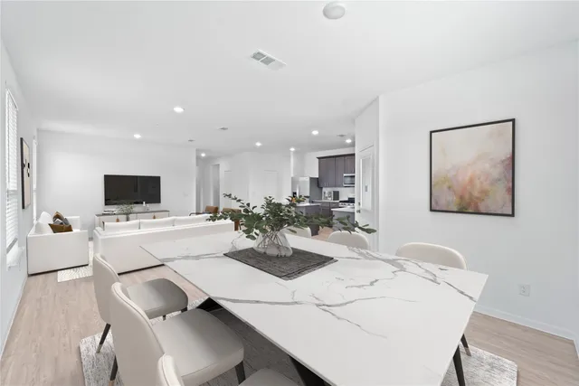 a kitchen with stainless steel appliances granite countertop a refrigerator sink and stove