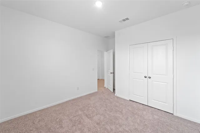 a view of a room that has a table and chairs in it