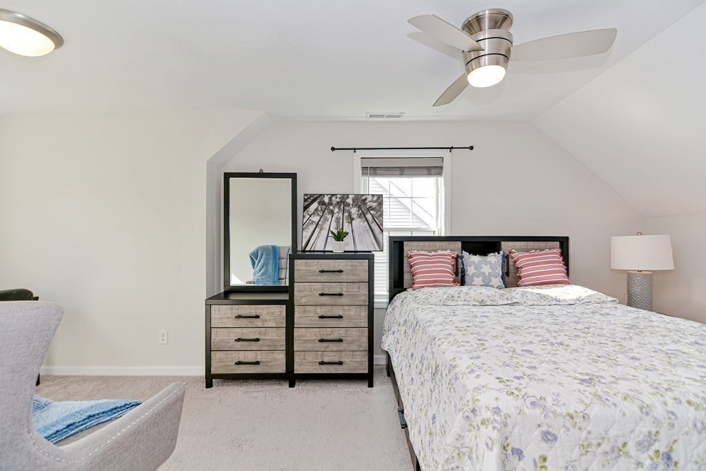 32 Riley Road, Unit 32 Tyngsboro, MA 01879 - Photo 25 of 35 a bedroom with a bed and a chandelier