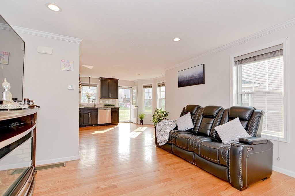 32 Riley Road, Unit 32 Tyngsboro, MA 01879 - Photo 6 of 35 a living room with furniture and a flat screen tv