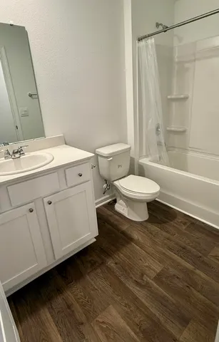 a bathroom with a toilet a sink and bathtub