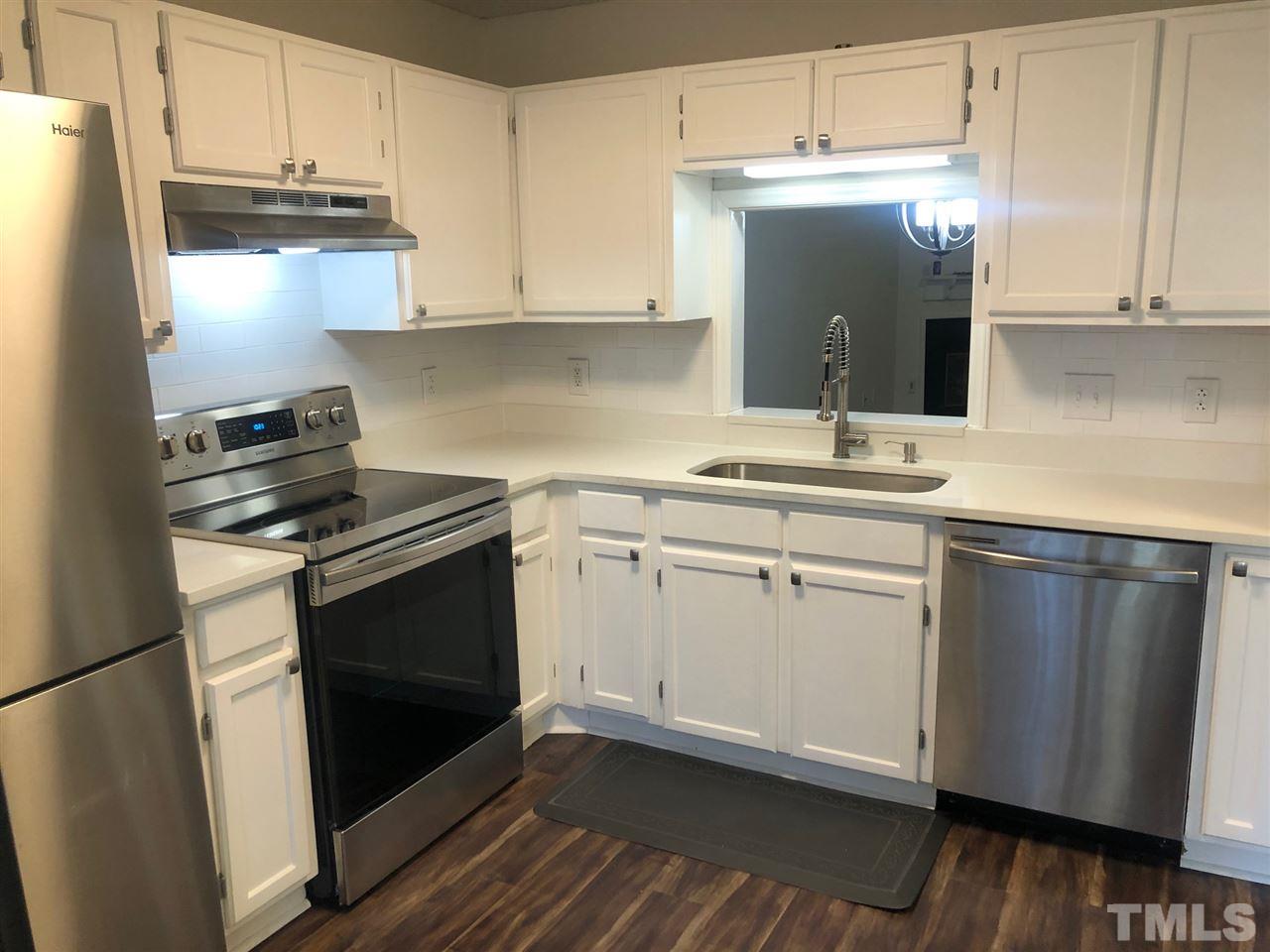 4621 Timbermill Court, Unit 103 Raleigh, NC 27612 - Photo 2 of 13 a kitchen with a sink stove and cabinets