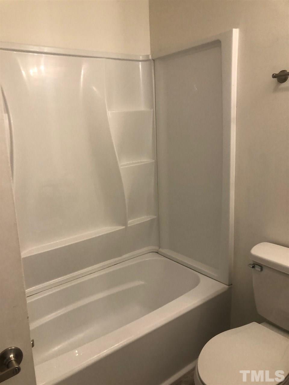 4621 Timbermill Court, Unit 103 Raleigh, NC 27612 - Photo 11 of 13 a bathroom with a shower and a toilet